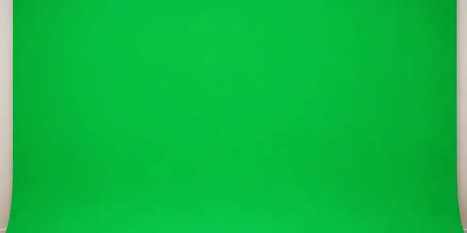 Chroma-key green screen photo booth backdrop on a hardwood floor