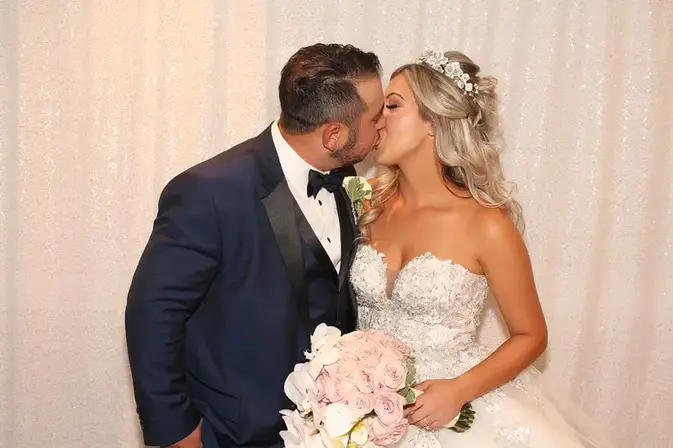 Newlyweds posing together in a photo booth at a Toronto wedding
