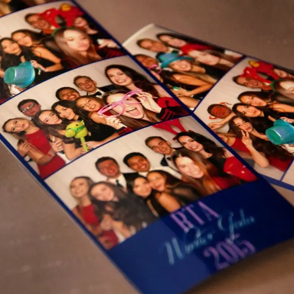 Assorted photobooth strips showcasing a lively and diverse group of partygoers with playful props, from oversized glasses to plush toys, celebrating at a 2015 New Year's Gala, memories preserved by Rent a PhotoBooth photobooth rentals.
